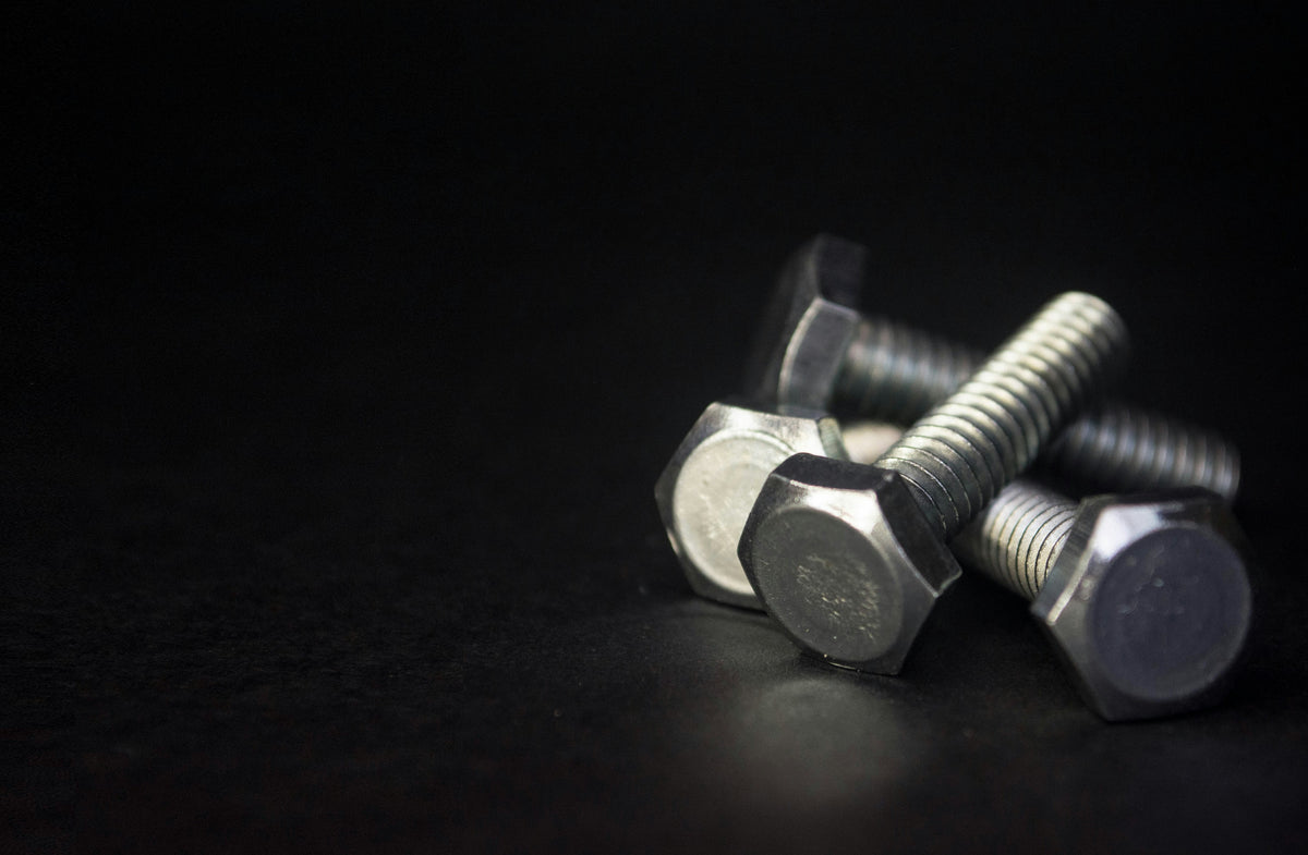 Metal bolts on a black background