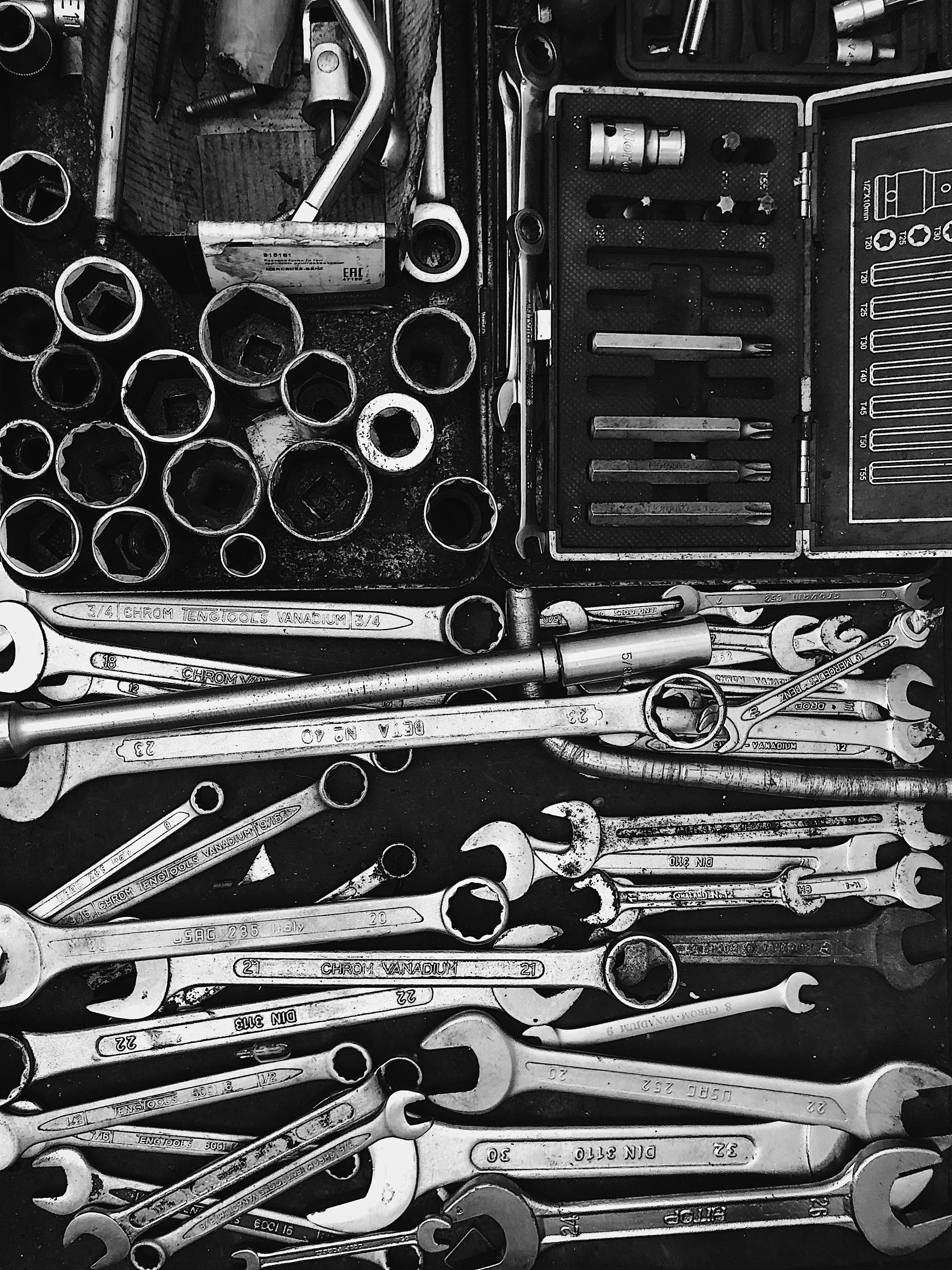Collection of wrenches and other tools on a dark surface